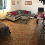 Salon confortable avec canapé, TV et et cheminée au gîte de Baleyssagues